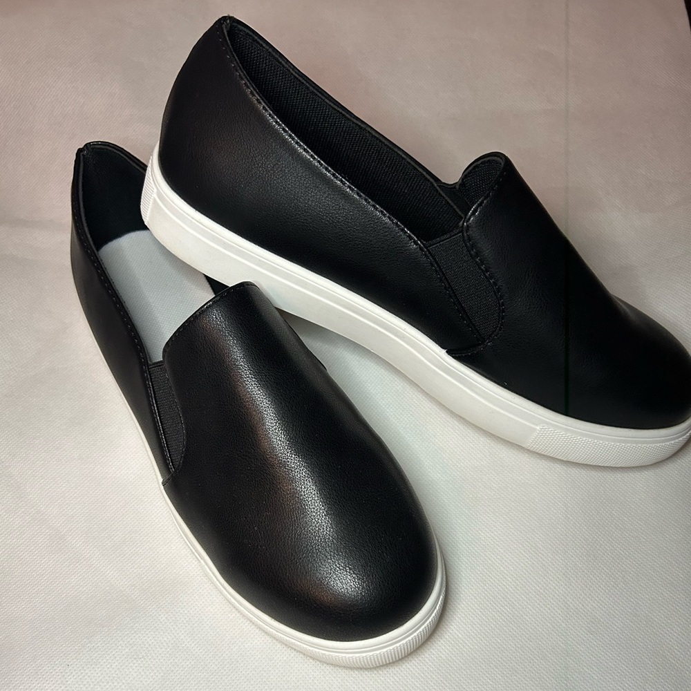 Black and white slip ons